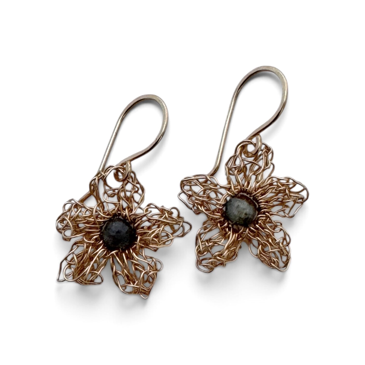 A pair of handmade wire-wrapped flower dangle earrings with dark gray labradorite stone centers, shown on a clean white background.