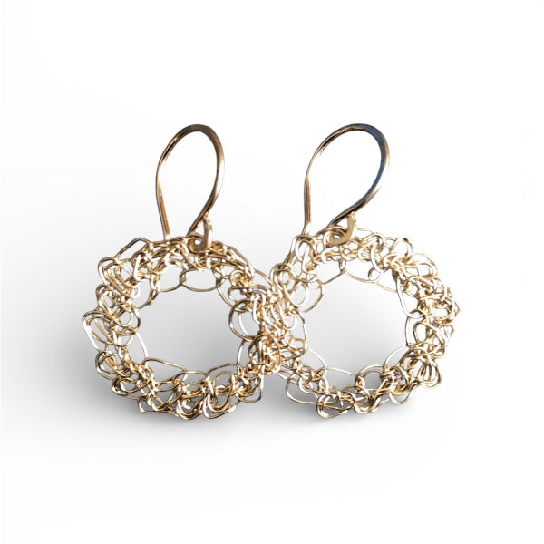 Gold chain earrings on a white background