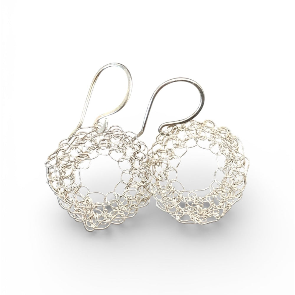 Silver crochet hoop earrings on a white background