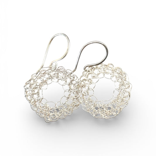 Silver crochet hoop earrings on a white background