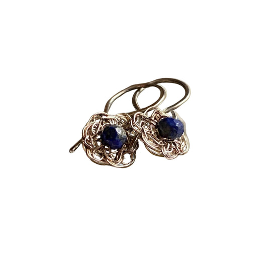 A pair of silver wire crochet drop earrings with dark blue lapis lazuli beads.